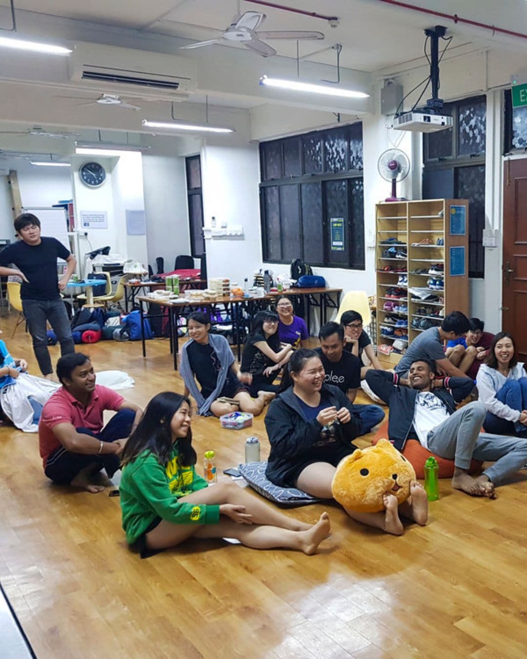 Blossom Youth Centre – Relaxed Group Study and Bonding Space Group of young people sitting on the wooden floor in Blossom Youth Centre