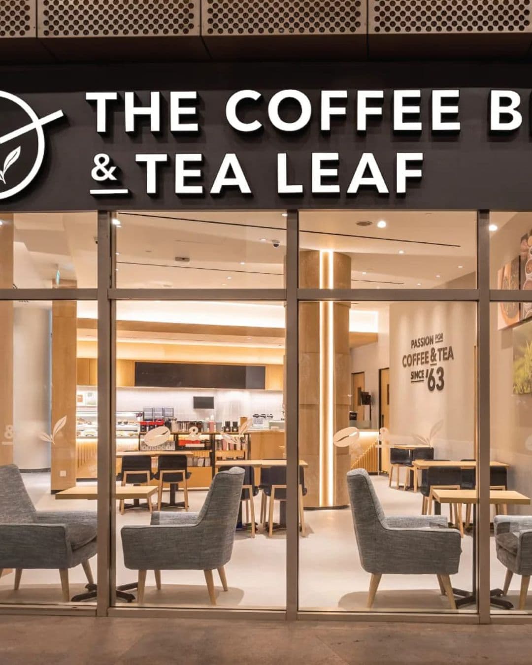 The Coffee Bean & Tea Leaf – Luxurious and Serene Study Café Luxurious glass entrance to The Coffee Bean & Tea Leaf with ambient lighting and study areas