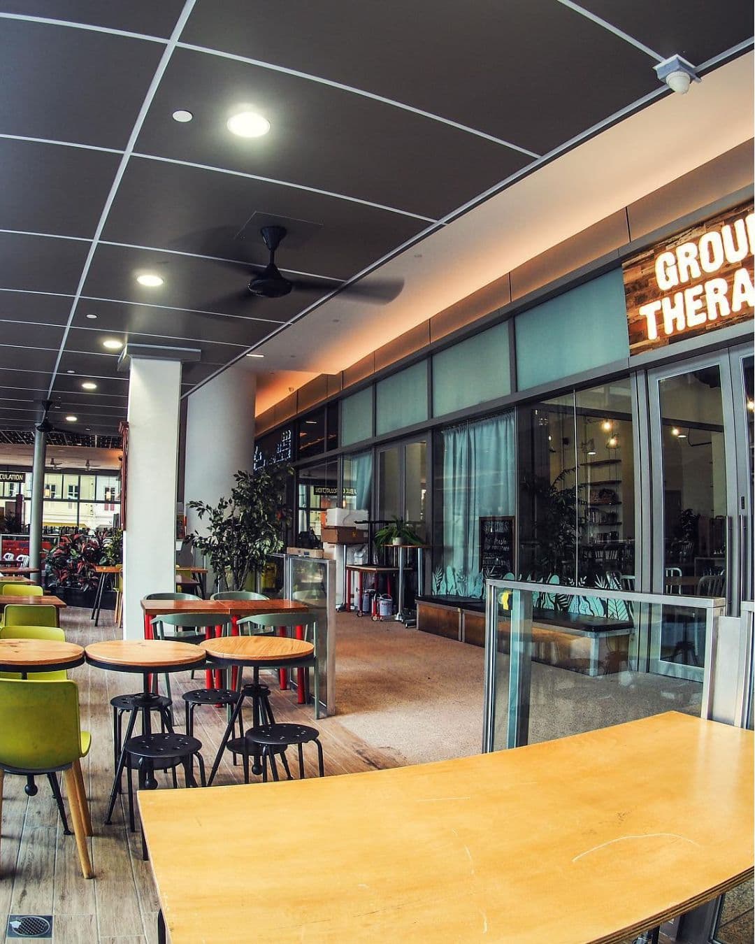 Group Therapy Café – Vibrant Outdoor-Indoor Study Café in Singapore Colorful exterior of Group Therapy café with visible seating and glass walls