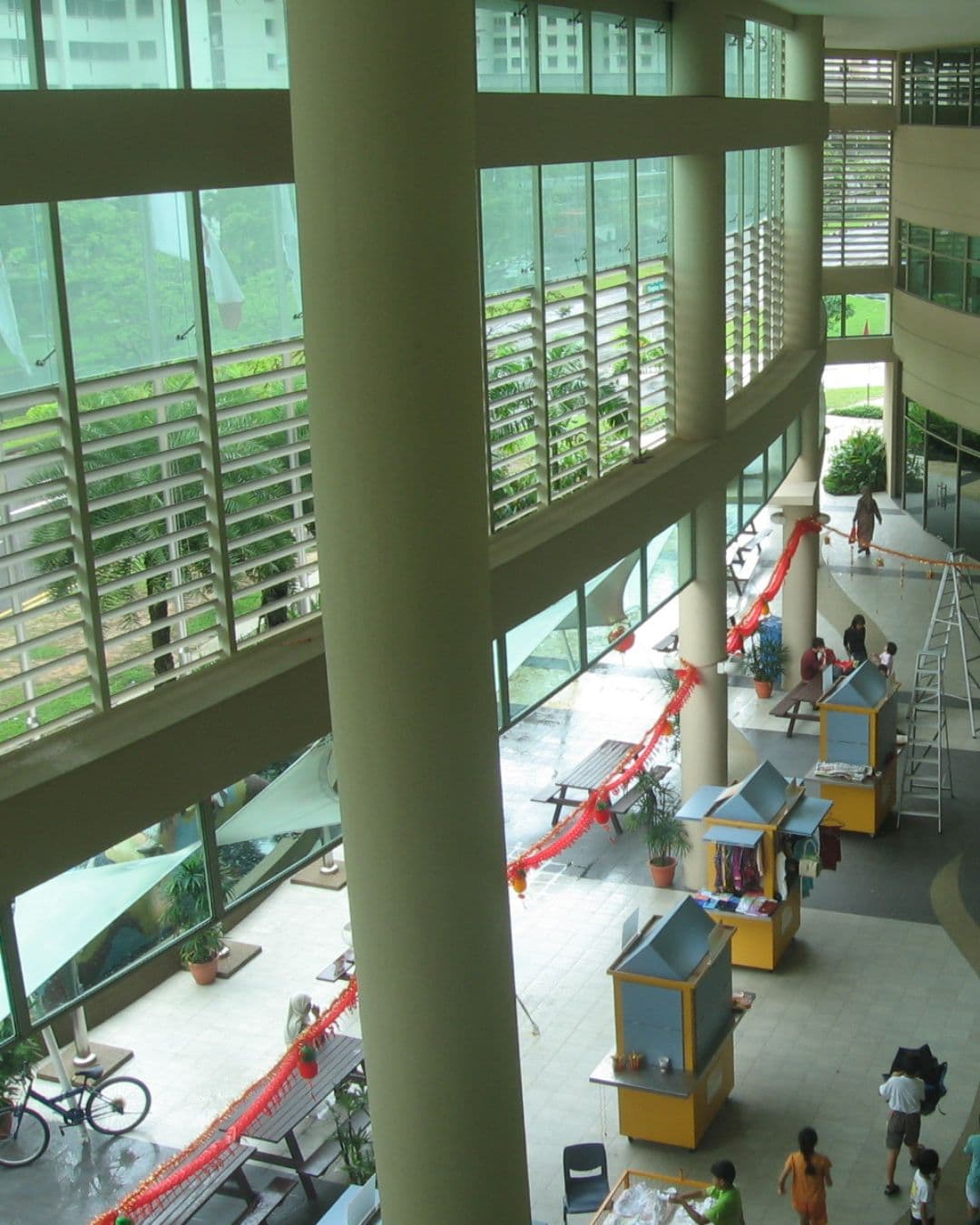 Sengkang Community Club – Rooftop-Like Outdoor Study Vibes Top-level outdoor view of Sengkang Community Club with people sitting and lush surroundings