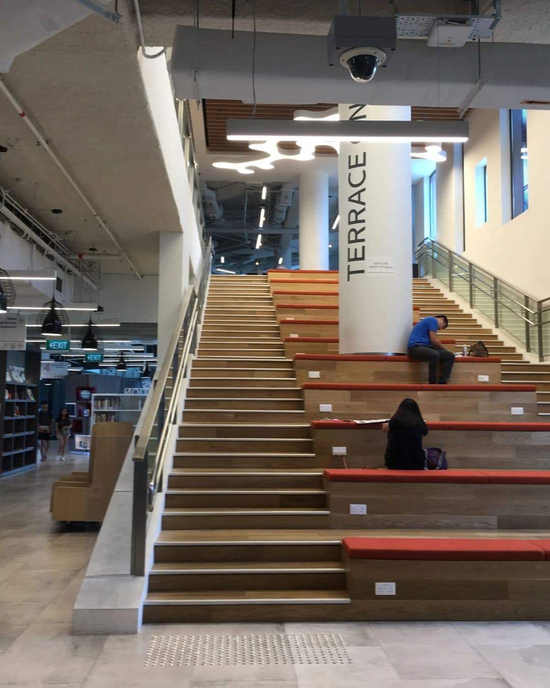 Tampines Regional Library – Study on Cushioned Staircase Zones Central staircase at Tampines Library turned into seating and study area with sockets and cushions