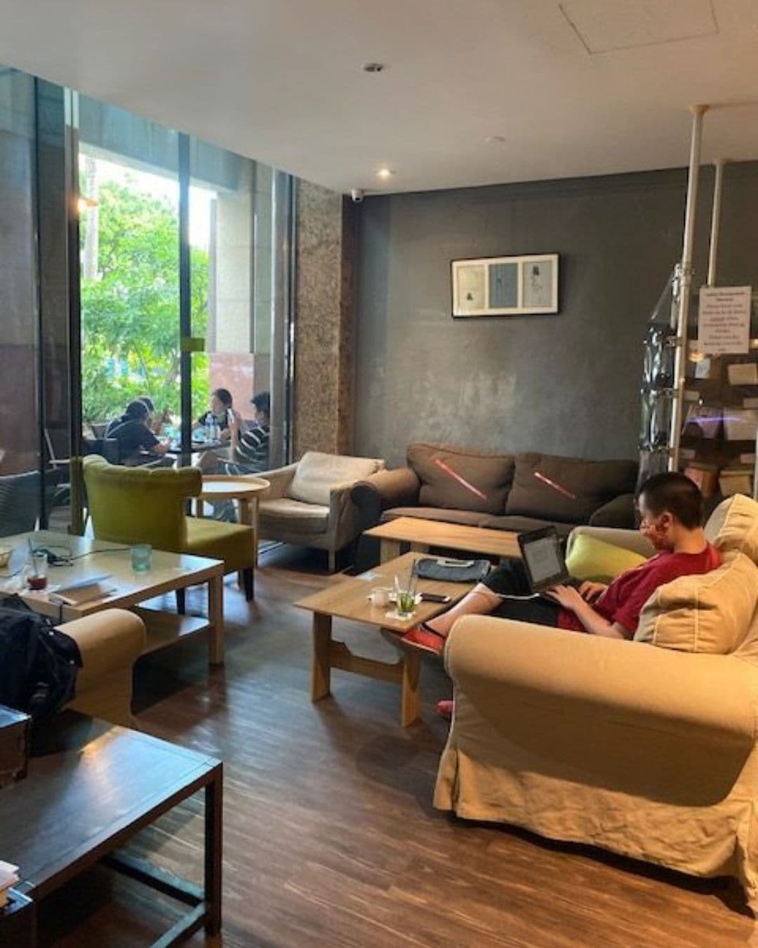 The Book Café – A Cozy Glass-Walled Study Haven in Singapore Interior of The Book Café in Singapore showing people studying inside cozy, glass-walled seating space